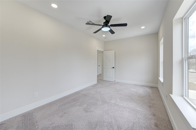 spare room with recessed lighting, baseboards, light colored carpet, and a ceiling fan