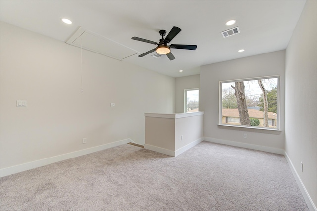 unfurnished room with attic access, recessed lighting, baseboards, and visible vents