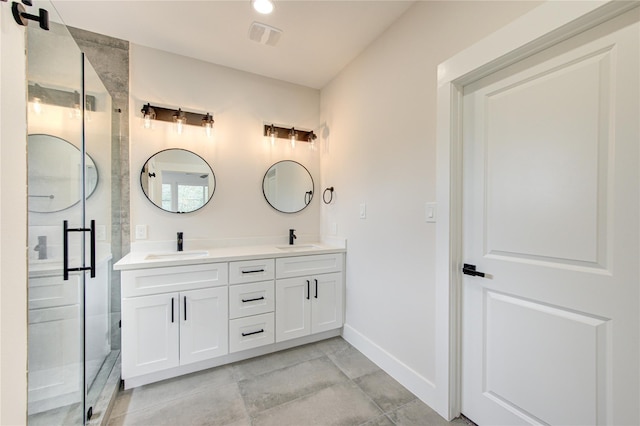 bathroom with a sink, baseboards, a shower stall, and double vanity