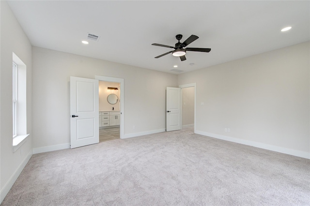 unfurnished bedroom with recessed lighting, light colored carpet, visible vents, and baseboards