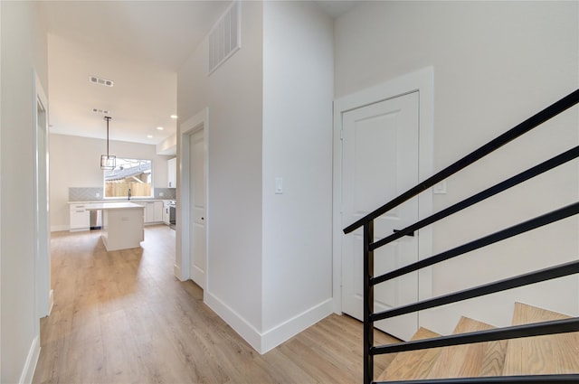 interior space featuring visible vents, baseboards, and wood finished floors