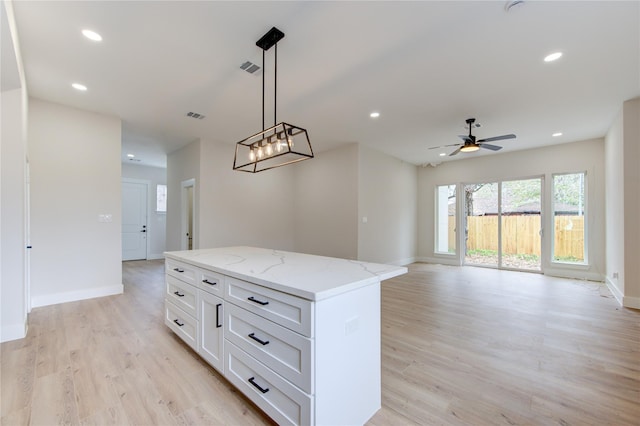 kitchen with visible vents, a center island, recessed lighting, light wood-style flooring, and white cabinets