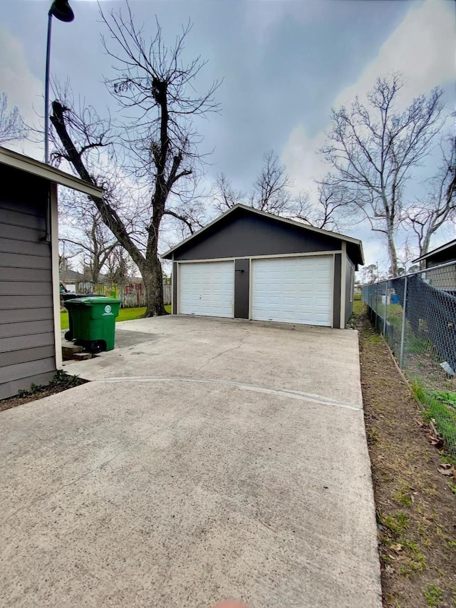 detached garage featuring fence