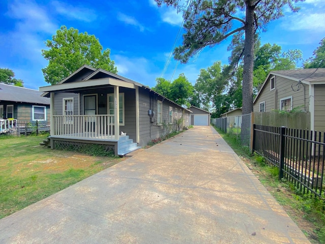 132 Grothe Ln, Houston, TX 77022 - view of front of property featuring covered porch, a detached garage, and an outdoor structure