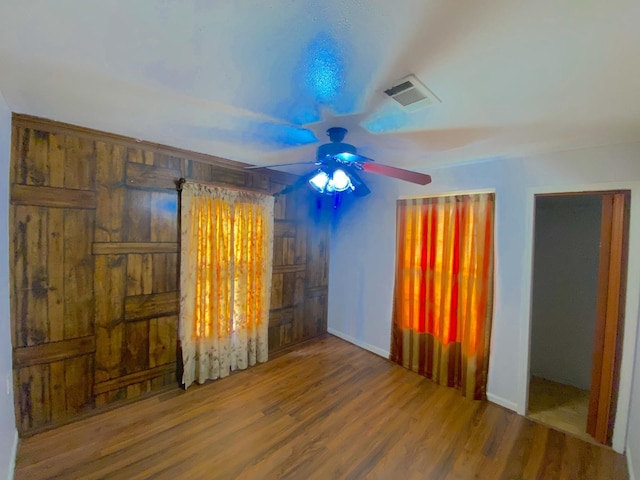 132 Grothe Ln, Houston, TX 77022 - unfurnished bedroom with wood finished floors, baseboards, and a ceiling fan