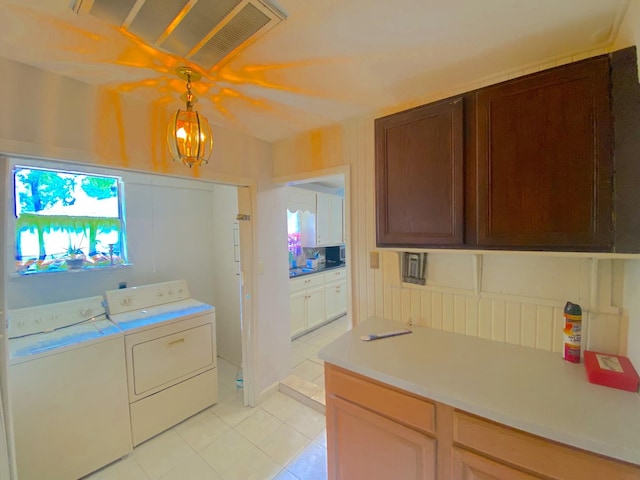 132 Grothe Ln, Houston, TX 77022 - washroom featuring washing machine and clothes dryer, light tile patterned floors, and plenty of natural light