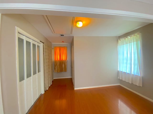 132 Grothe Ln, Houston, TX 77022 - empty room featuring attic access, wood finished floors, and baseboards