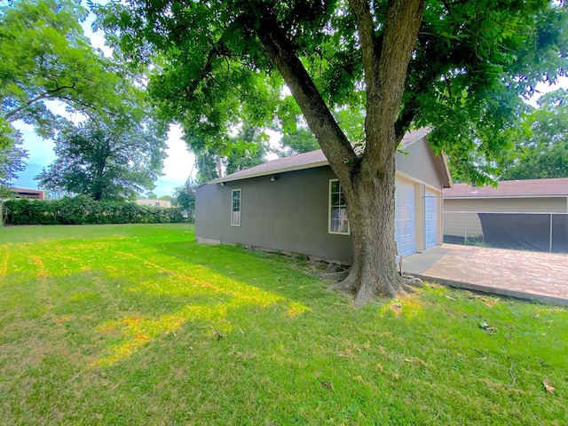 132 Grothe Ln, Houston, TX 77022 - view of green lawn featuring a garage