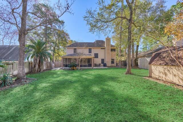 view of yard with a fenced backyard and a sunroom