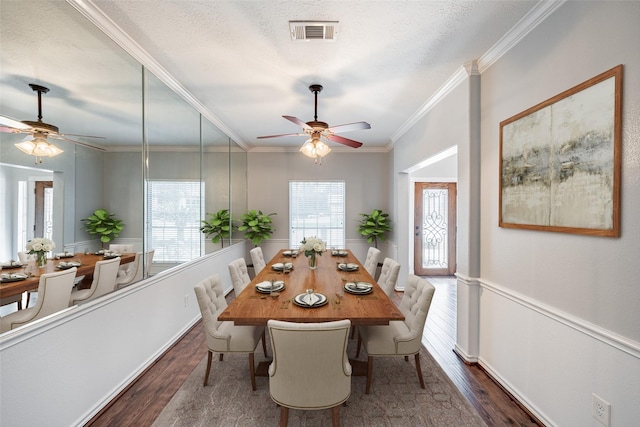 dining area with wood finished floors, visible vents, and a wealth of natural light