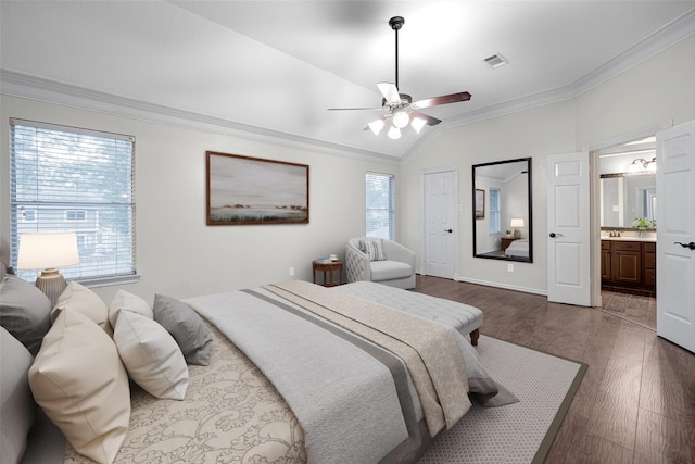 bedroom featuring visible vents, dark wood-style floors, connected bathroom, crown molding, and vaulted ceiling