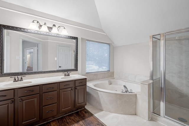 full bath featuring a sink, a stall shower, and vaulted ceiling