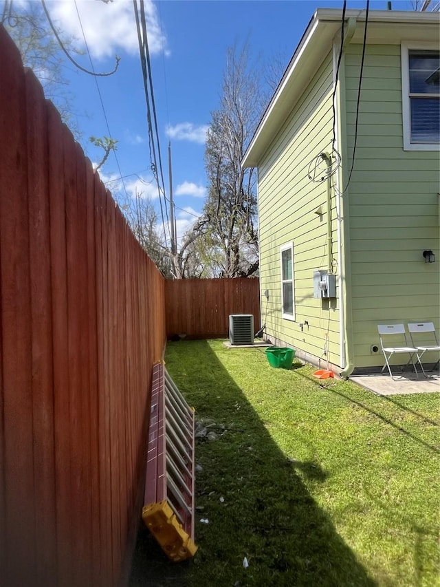 view of yard with a patio area, cooling unit, and a fenced backyard