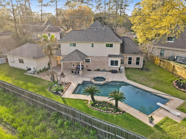 view of pool with a lawn, a patio, a pool with connected hot tub, and a fenced backyard