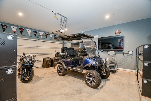 garage with recessed lighting, a garage door opener, and baseboards