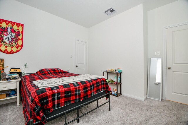 bedroom with visible vents, baseboards, and carpet