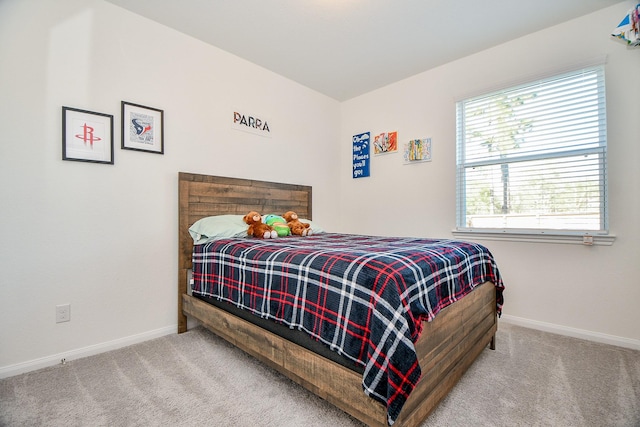 carpeted bedroom featuring baseboards