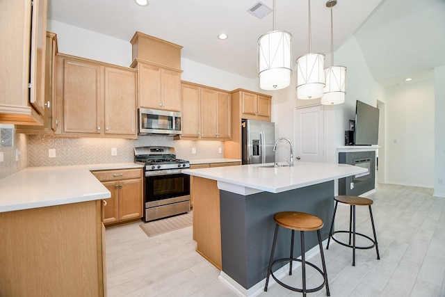 kitchen with a sink, visible vents, tasteful backsplash, and appliances with stainless steel finishes