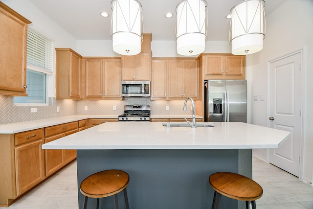 kitchen with decorative backsplash, a kitchen breakfast bar, stainless steel appliances, and a sink