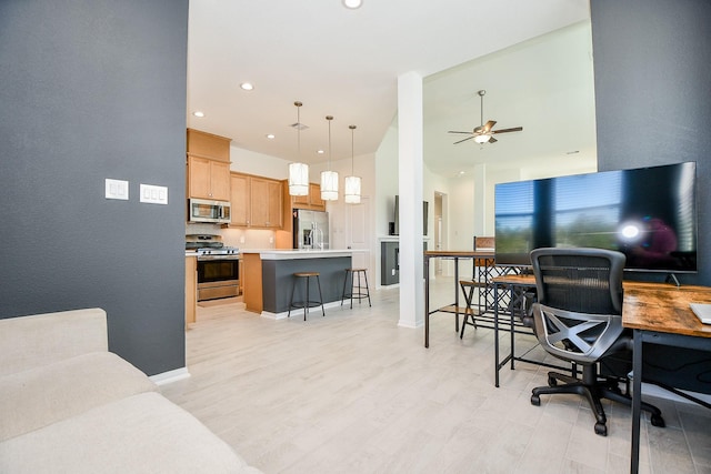 office area featuring recessed lighting, baseboards, light wood-style flooring, and a ceiling fan