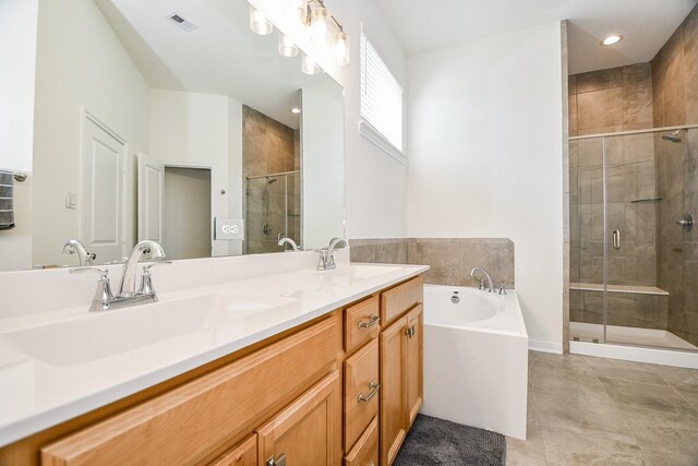 bathroom with a bath, a shower stall, double vanity, and a sink