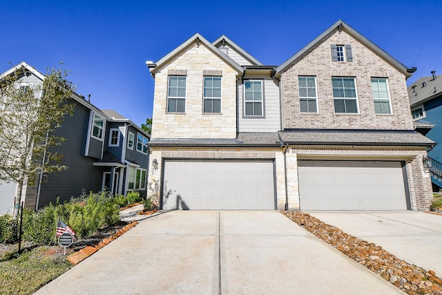 view of front of house featuring stone siding, brick siding, concrete driveway, and an attached garage