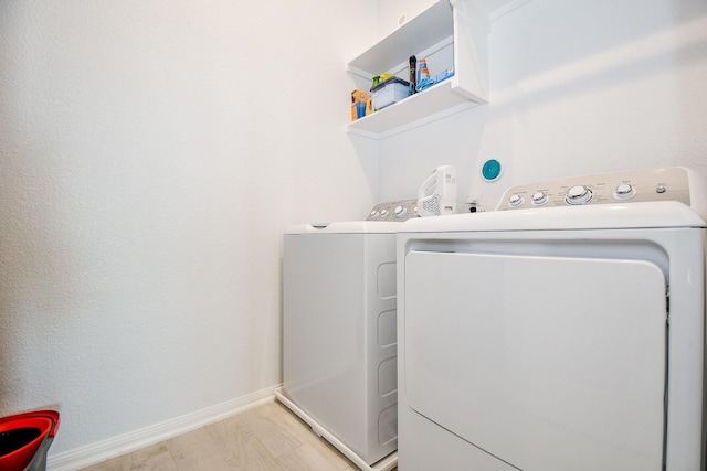 laundry area with washer and clothes dryer, laundry area, and baseboards