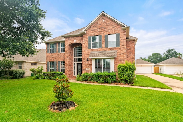 traditional-style home featuring brick siding, a garage, and a front yard