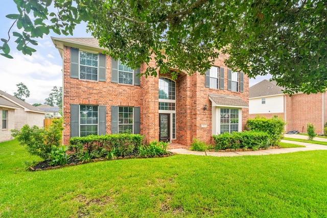 view of front facade featuring a front lawn and brick siding