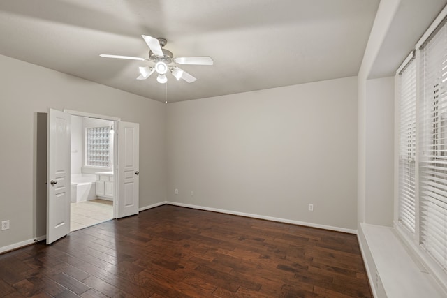 unfurnished bedroom with multiple windows, baseboards, and wood-type flooring