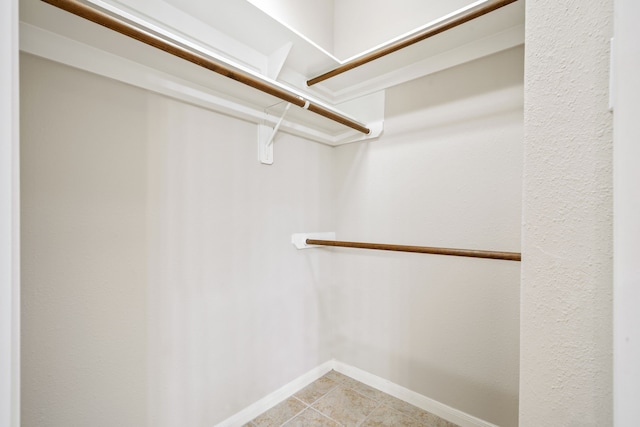 walk in closet featuring light tile patterned floors