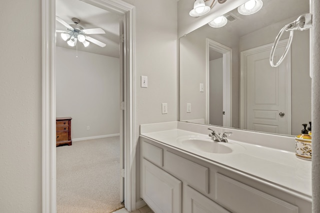 bathroom with vanity, a ceiling fan, visible vents, and baseboards