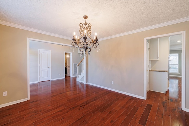 spare room featuring stairway, baseboards, dark wood-type flooring, a textured ceiling, and crown molding