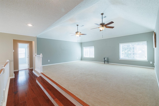 spare room featuring visible vents, baseboards, and lofted ceiling