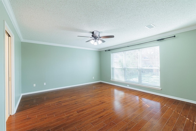 unfurnished room featuring visible vents, ornamental molding, baseboards, and wood finished floors