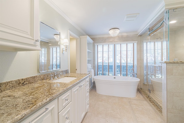 bathroom with vanity, crown molding, visible vents, and a freestanding bath