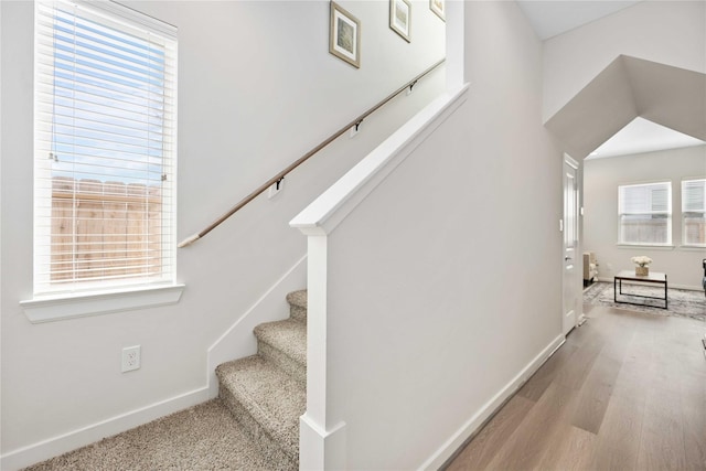 stairway with baseboards and wood finished floors