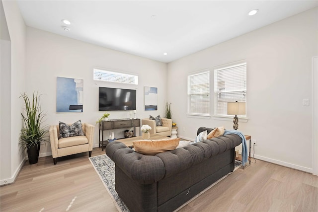 living area with recessed lighting, light wood-style flooring, and baseboards