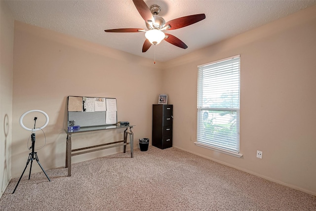 misc room featuring a ceiling fan, carpet, and a textured ceiling