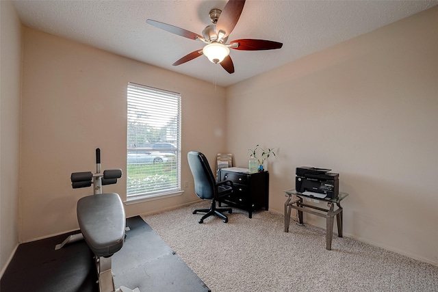 office space featuring baseboards, a textured ceiling, and ceiling fan