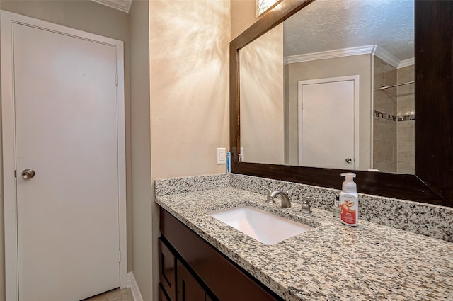 bathroom with vanity, a textured ceiling, and crown molding