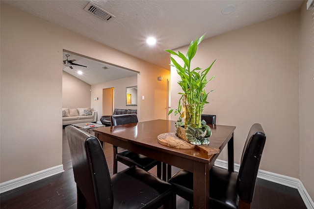 dining area with dark wood-style floors, visible vents, baseboards, lofted ceiling, and ceiling fan