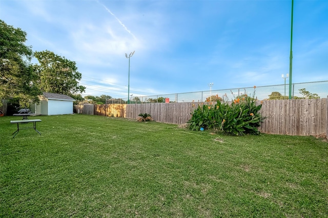 view of yard with an outbuilding and a fenced backyard