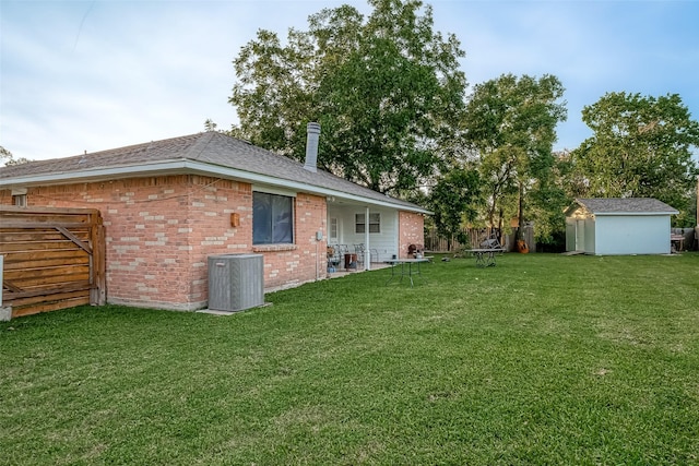 view of yard featuring cooling unit, an outbuilding, a shed, and fence