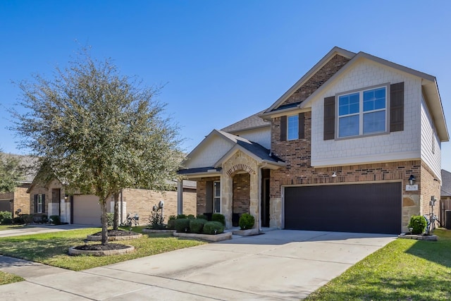 craftsman house featuring brick siding, concrete driveway, a garage, and a front yard