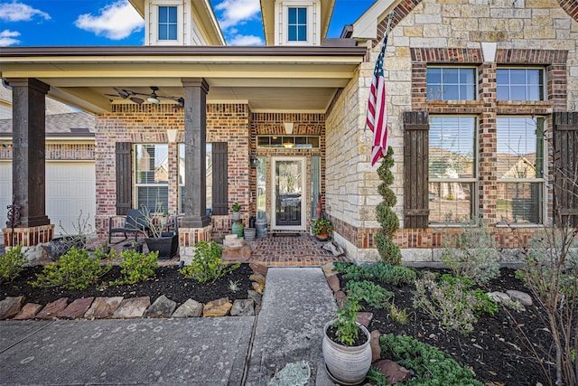 view of exterior entry with stone siding, a porch, and ceiling fan