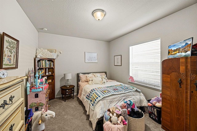 bedroom with light colored carpet and a textured ceiling