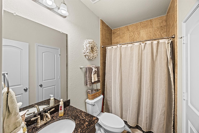 bathroom with vanity, a shower with shower curtain, a textured ceiling, toilet, and a textured wall