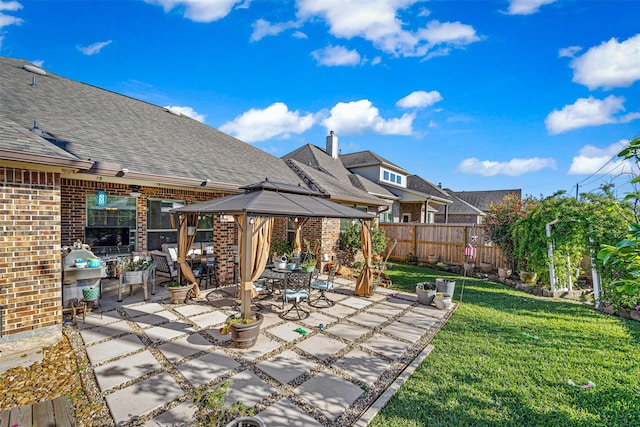 view of patio featuring a gazebo and fence