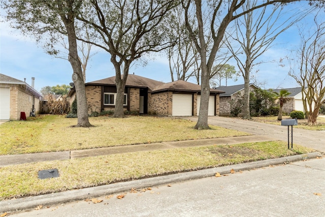 view of front of home with a front yard, an attached garage, brick siding, and driveway